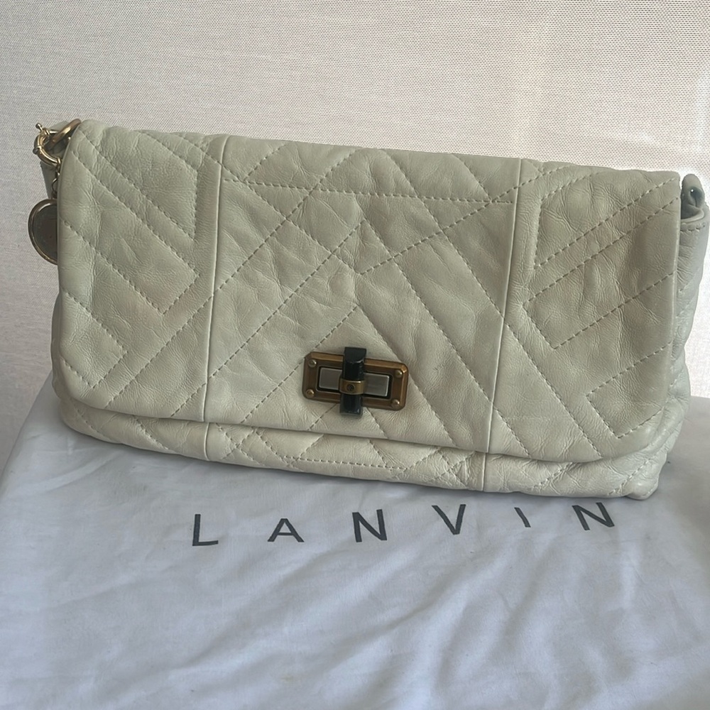 Genuine leather clutch , cream color with coin hardware with beautiful lining .
